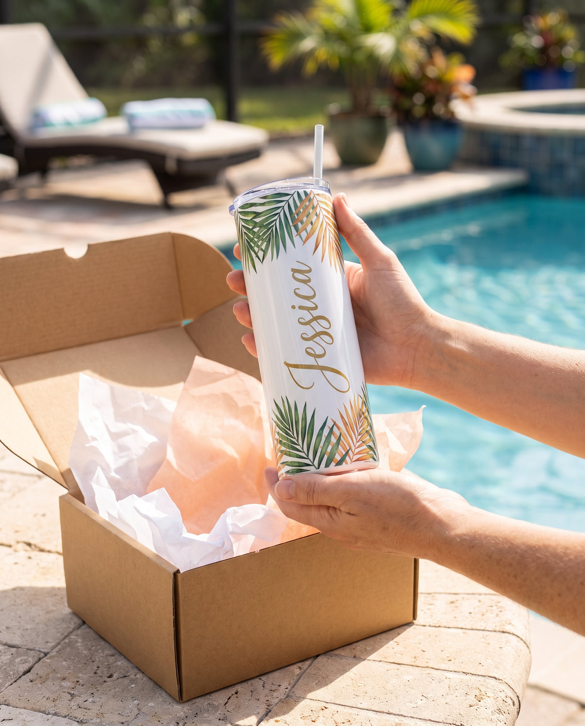 Personalized tumbler being unboxed as a gift by the pool