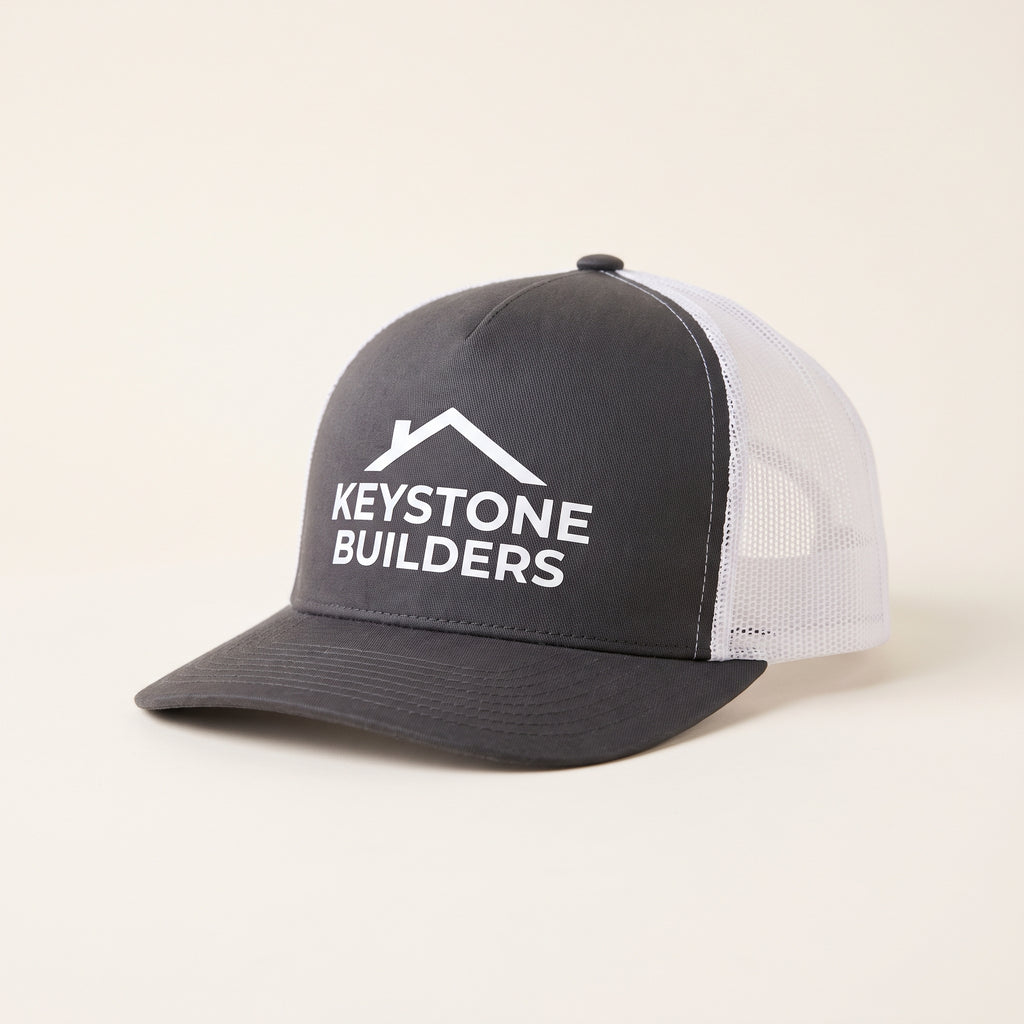 Custom 5-panel mesh back trucker hat in charcoal and white with a builders logo